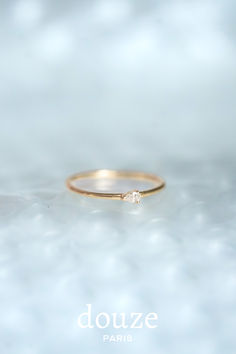 a gold ring with a single diamond on it