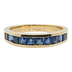 A very fine gold & sapphire half eternity band ring.  By Tiffany & Co.   In 18 yellow gold.  With channel set square-cut faceted sapphires to the top and a solid band to the reverse.  Simply a wonderful ring by Tiffany & Co.!  Date: 20th Century  Overall Condition: It is in overall good, as-pictured, used estate condition with some very fine & light surface scratches and other signs of expected light wear consistent with age.  Fineness: Marked 750 for 18k gold fineness.   Marks: TIFFANY & Co. / 750  Measurements: Width: ca. 4 mm Diameter: ca. 19 mm  Weight: ca. 3 grams   Ring Size: 4.75  Gemstone Measurements: 10 Square-cut Sapphires: each ca. 3 mm Width Vintage Blue Sapphire Ring, Sapphire Wedding Ring Set, Sapphire Eternity Band, Modern Wedding Rings, Vintage Sapphire Ring, Mens Gold Wedding Band, Sapphire Wedding Rings, Sapphire Wedding Band, Rings Mens Wedding Bands