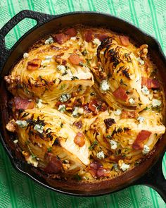 an iron skillet filled with food on top of a green and white table cloth