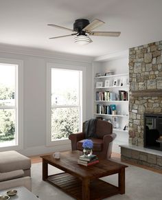 a living room filled with furniture and a fire place in front of a stone fireplace