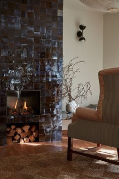 a living room with a chair and fire place