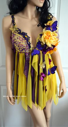 a female mannequin wearing a yellow and purple dress with flowers on the chest