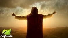 a person with their arms outstretched in front of a cloudy sky and the sun behind them