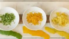 three white bowls filled with different types of food on top of a marble countertop