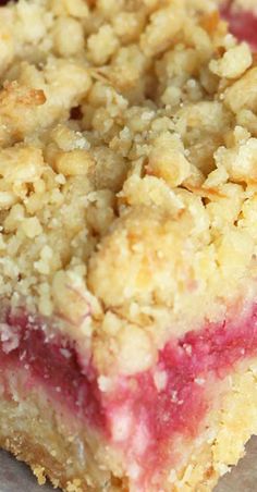 a close up of a piece of cake on a plate with crumb toppings