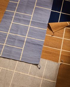 a piece of cloth is laying on the floor next to an orange and blue rug