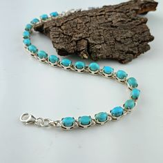 "This beautiful tennis bracelet handmade of 925 sterling silver studded with prong set oval turquoise cabochon gemstone best gift for women and girls. 925 Sterling Silver Bracelet, Turquoise Bracelet, Dainty Turquoise Tennis Bracelet for Women, Turquoise Jewelry, Arizona Kingman Turquoise ✦ PRODUCT DETAILS ✣ Product Weight:--------10.40 grams (Approx.) ✣ Metal:----------------------925 Sterling Silver ✣ Stamp:---------------------925 ✣ Stone:---------------------Turquoise ✣ Stone Size:---------------6 x 4 mm ✣ Stone Shape:------------Oval ✣ Bracelet Length:--------7\" Inch Adjustable (Approx.) NOTE:- The pattern and color of the stone may vary slightly from reality. But you will receive the same product as shown in the photo. ✦ THIS PRODUCT CAN BE GIFTED ON THE FOLLOWING OCCASIONS Christma Turquoise Round Cabochon Bracelets, Turquoise Cabochon Round Bracelets, Turquoise Cabochon Bracelet, Sterling Silver Turquoise Oval Bracelet Gift, Adjustable Oval Turquoise Sterling Silver Bracelet, Handmade Turquoise Oval Sterling Silver Bracelet, Handmade Turquoise Sterling Silver Oval Bracelet, Handmade Oval Turquoise Sterling Silver Bracelet, Elegant Turquoise Oval Sterling Silver Bracelet