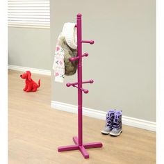 a child's clothing rack with two pairs of shoes on the floor next to it