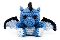 a crocheted blue and black dragon stuffed animal