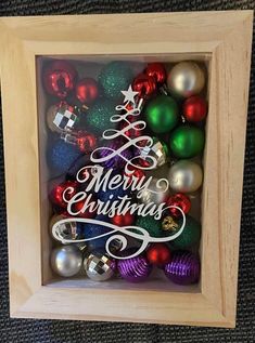 a wooden frame filled with christmas ornaments