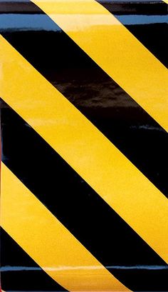 a black and yellow striped square plate with red border around the edges, on a white background