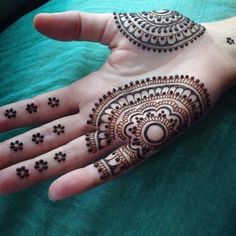 a person's hand with henna tattoos on it