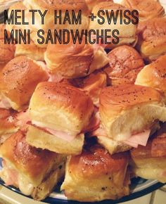 a plate full of ham and swiss mini sandwiches