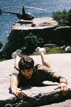 a man laying on the ground with his hands in the air