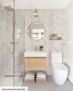 a bathroom with a toilet, sink and mirror