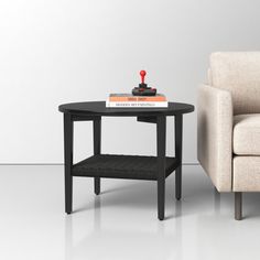 a small table with a book on it next to a couch and chair in a white room