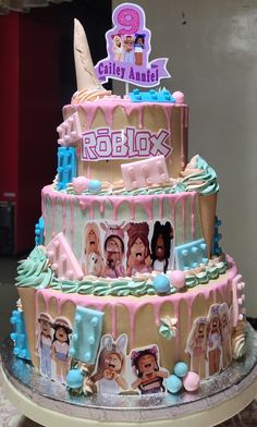 a large cake decorated with pictures of people on the front and sides, in pastel colors