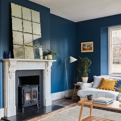 a living room with blue walls and a fireplace