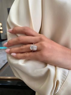 a woman's hand with a diamond ring on it