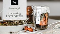 a white bowl filled with lots of food next to a jar full of dried herbs