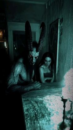 a woman sitting at a table in front of an evil demon