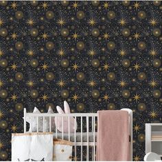 a baby's room with stars on the wall and a crib next to it