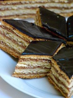 several pieces of cake on a white plate