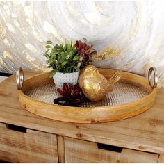 a wooden tray with metal handles and some plants in it on top of a table