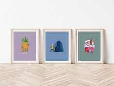 three framed art prints on a wall above a wooden table with a cheetah, pineapple and ice cream cone