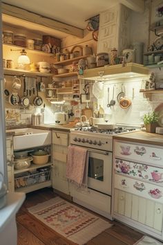 an old fashioned kitchen with lots of pots and pans on the wall above the stove