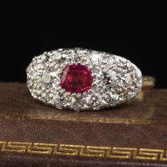 Beautiful Antique Art Deco 14K Yellow Gold Platinum Old Mine Diamond Burma Ruby Ring. This gorgeous saddle ring is crafted in 14k yellow gold and platinum. The center holds a natural Burmese ruby that appears to be untreated and is surrounded by old mine cut diamonds. The ring is in great condition and sits low on the finger. Item #R1660 Metal: 14K Yellow Gold and Platinum Weight: 5.2 Grams Size: 4 3/4 Ruby: Approximately .50 cts Diamonds: Approximately .60 ct Color: H Clarity: SI1 Measurements: Heirloom Red Diamond Cut Ring, Antique Diamond Cut Ruby Ring For Anniversary, Antique Ruby Ring With Diamond Cut For Anniversary, Hallmarked Platinum Cluster Ring In Yellow Gold, Exquisite Yellow Gold Collectible Rings, Platinum Hallmarked Ruby Ring, Heirloom Oval Ruby Ring With Diamond Cut, Collectible Yellow Gold Ruby Ring With Diamonds, Antique Brilliant Cut Ruby Ring For Wedding