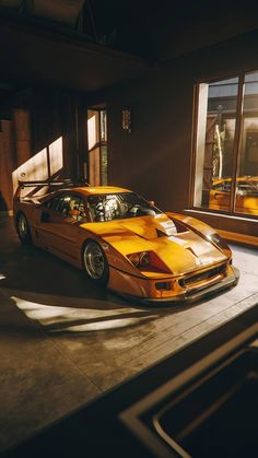 a yellow sports car parked in front of a window with the sun shining on it