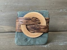 a wooden ring sitting on top of a rock