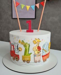 a birthday cake decorated with animals and train decorations