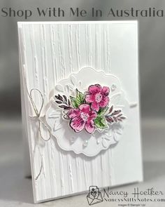 a white card with pink flowers on it