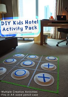 a hotel room with an activity board on the floor and a desk in the background