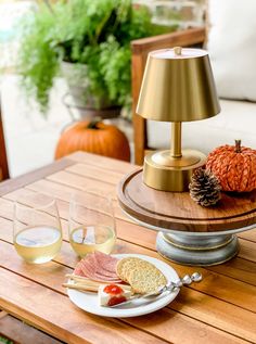 a wooden table topped with food and drinks