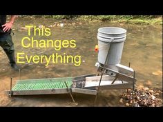 a man standing next to a bucket on top of a muddy river with the words, this changes everything