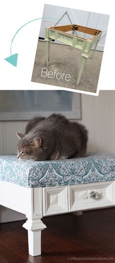 a cat laying on top of a bed with the bottom drawer open and side drawers closed