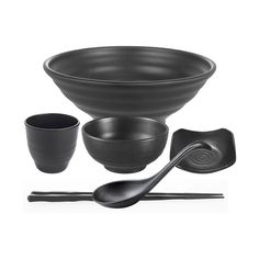 three black bowls with spoons and two cups