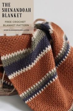 an orange and blue striped blanket next to a basket with yarn on it, the text overlay reads free crochet blanket pattern