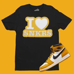 Stay stylish with this Air Jordan 1 High Yellow Ochre Matching T-Shirt from SNKADX. This classic sneaker match tee in black, yellow ochre and white is the perfect for any casual look. Crafted with natural materials, you'll stay comfortable all day. ▶▶T-SHIRT DETAILS ● This sneaker match tee is designed to match the Air Jordan 1 High Yellow Ochre ● This sneaker t-shirt is printed on an Adult Unisex size shirt (See Size Guide) ● Printed on Heavy Cotton Gildan 5000 Tee ● Custom Made - Not Jordan Brand or Nike ● We strive to color-match the actual sneakers. When an exact color match is unattainable we use the closest color code available. ▶▶ F E A T U R E S ✔️It feels soft and lightweight, with the right amount to stretch. ✔️It is comfortable and flattering for women & men. ✔️The double stitch Casual Yellow T-shirt With Team Name, Sneakerhead Gifts, Sneaker Match Tees, Yellow Ochre, Jordan 1 High, Air Jordan 1 High, Classic Sneakers, Exclusive Fashion, Crew Neck Shirt