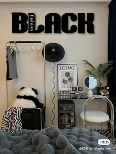 a bedroom with black and white decor on the wall