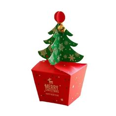 a small christmas tree sitting on top of a red box