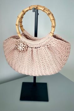 "This trendy wide-bottomed handbag is perfect for a casual shopping trip, or for a night on the town. It's versatile design compliments any occasion. This adorable purse is available in the color Blush  and features a rhinestone brooch for a little bit of flare. A shimmer yarn was added throughout the purse, and bamboo handles give this bag style without compromising functionality. Makes a perfect gift for anyone on your list.  Sizing- 11\" wide x 7\" deep, excluding handles  Care instructions- Boho Fringe, Color Blush, Crochet Cowl, Bamboo Handles, Pom Pom Hat, Bag Style, Rhinestone Brooches, Estilo Boho, Crochet Fashion