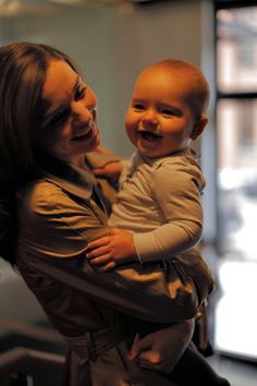 a woman holding a baby in her arms