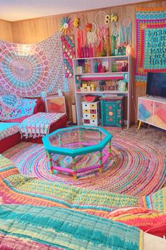 a living room filled with lots of colorful furniture and rugs on top of it