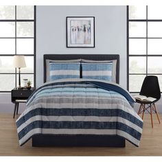 a bed with blue and white striped comforter