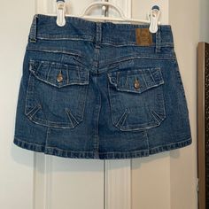 Candies Brand Denim Mini Skirt Size 1. Never Worn, Like New!! Casual Denim Blue Skort With Pockets, Casual Denim Skort With Pockets, Dark Wash Cotton Skort Casual Style, Casual Dark Wash Skort With Pockets, Casual Dark Wash Cotton Skort, Dark Wash Cotton Casual Skort, Casual Mid-rise Denim Mini Skirt, Y2k Mid-rise Denim Skort, Y2k Style Mid-rise Denim Skort