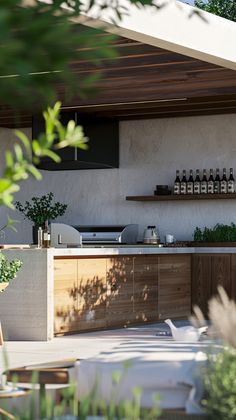 an outdoor bar with bottles on the back wall and plants in pots next to it